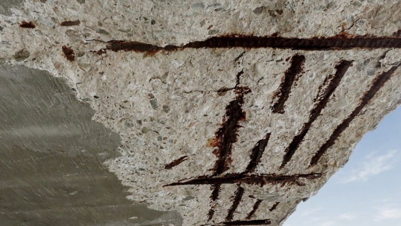 Spalled parking-deck concrete slab with corroded reinforcing steel